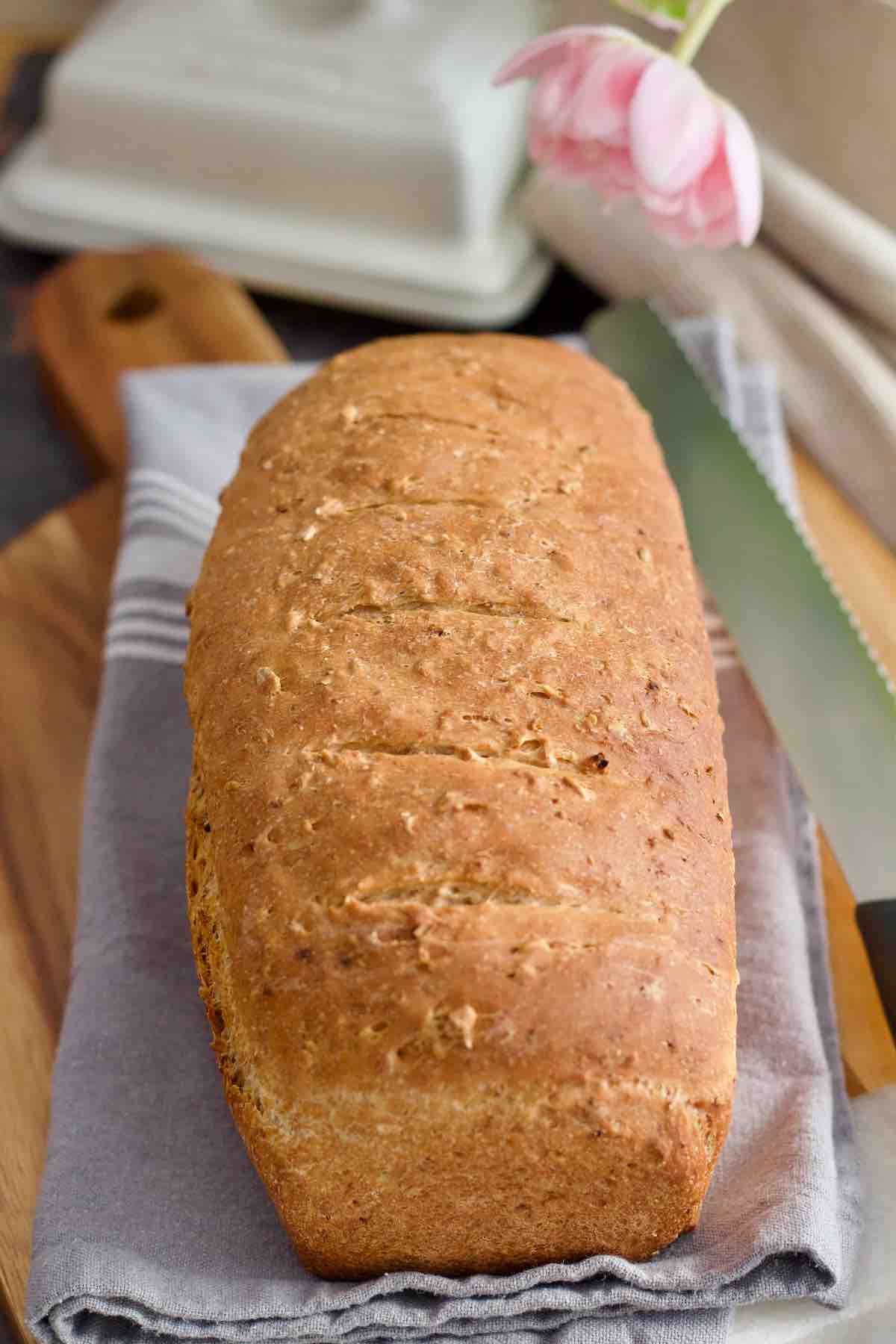 Entire granary bread loaf on top of kitchen towel.