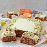 Carrot cake traybake with two slices in front of it.