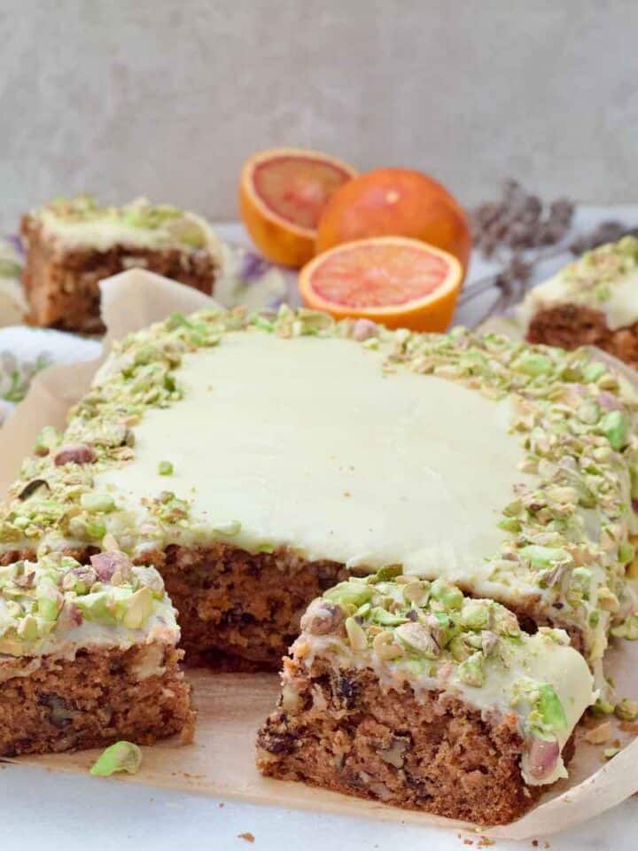 Carrot cake traybake with two slices in front of it.