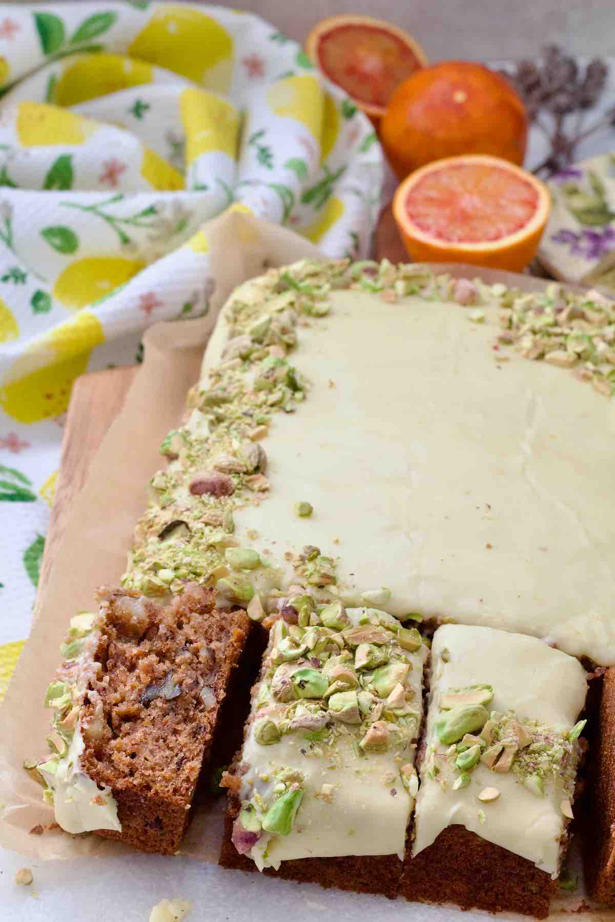 Carrot cake traybake and three slices, one on its side.