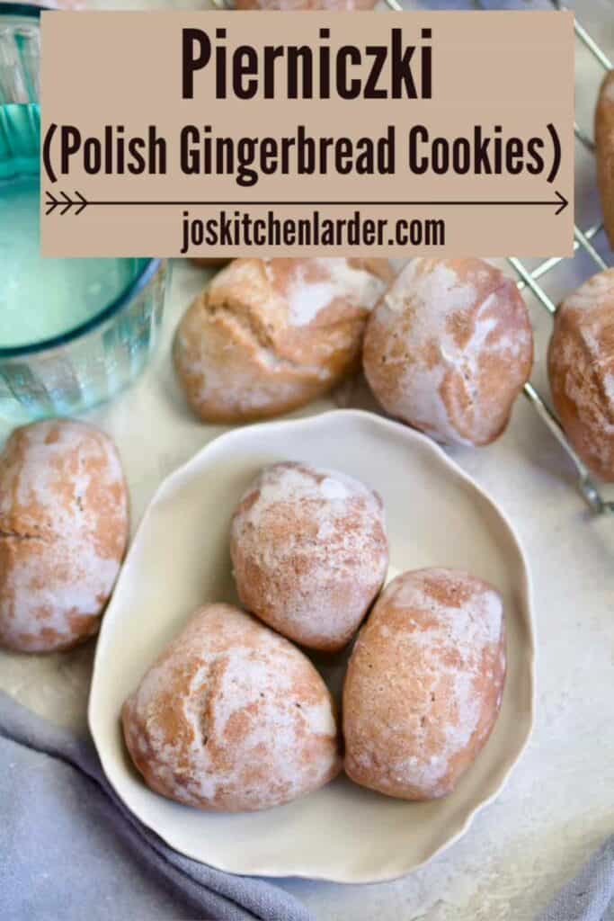 Three pierniczki on a plate, glass of water, more pierniczki around.