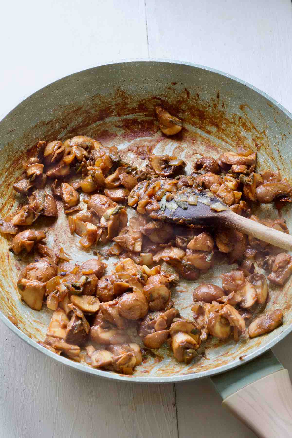 Frying pan with sautéed mushrooms and onions.