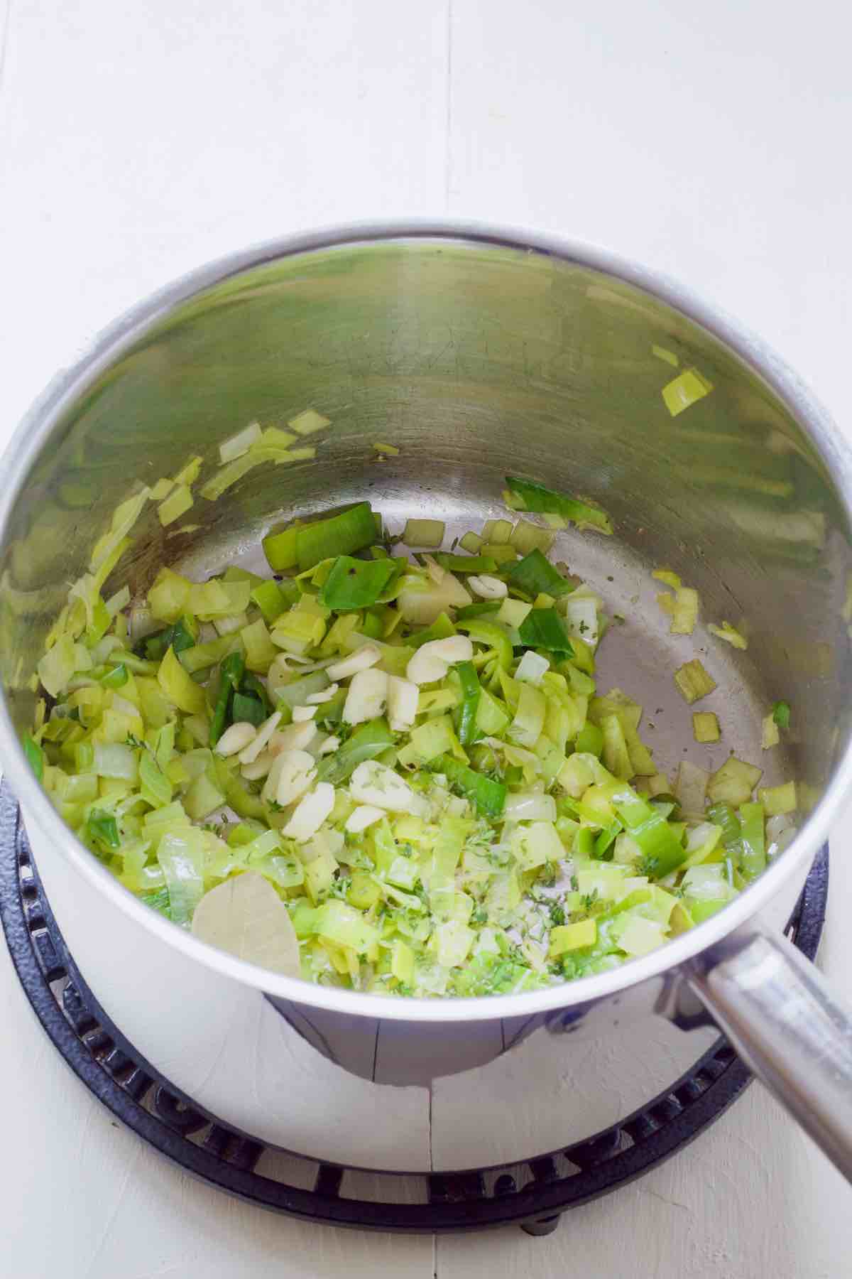 Garlic and herbs added on top of sautéed leeks.