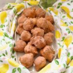 Platter piled up with mini doughnuts.