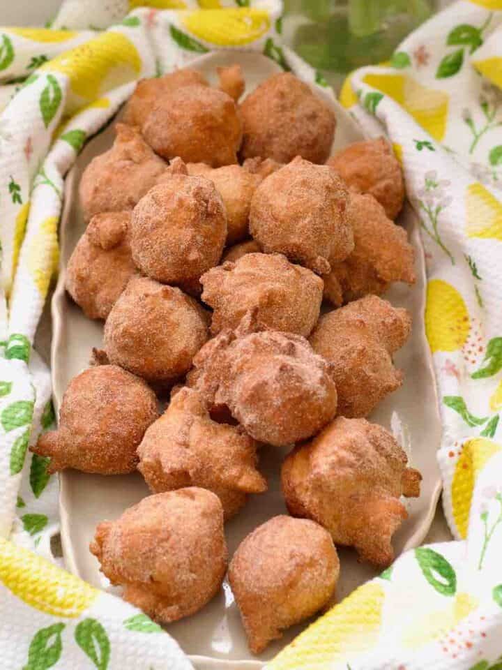 Platter piled up with mini doughnuts.