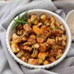 Close up of roasted swede in a serving dish.