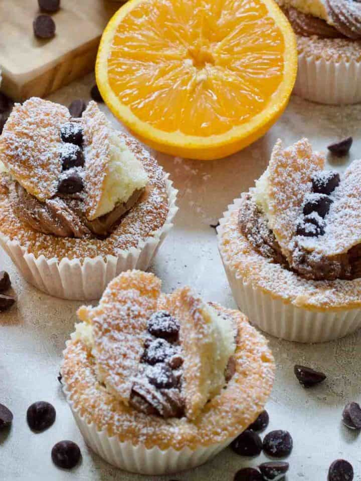 Close up of three chocolate orange butterfly cakes - square.