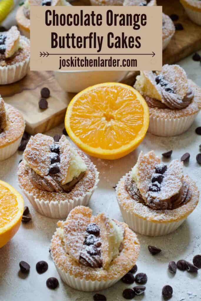 Close up of three chocolate orange butterfly cakes.