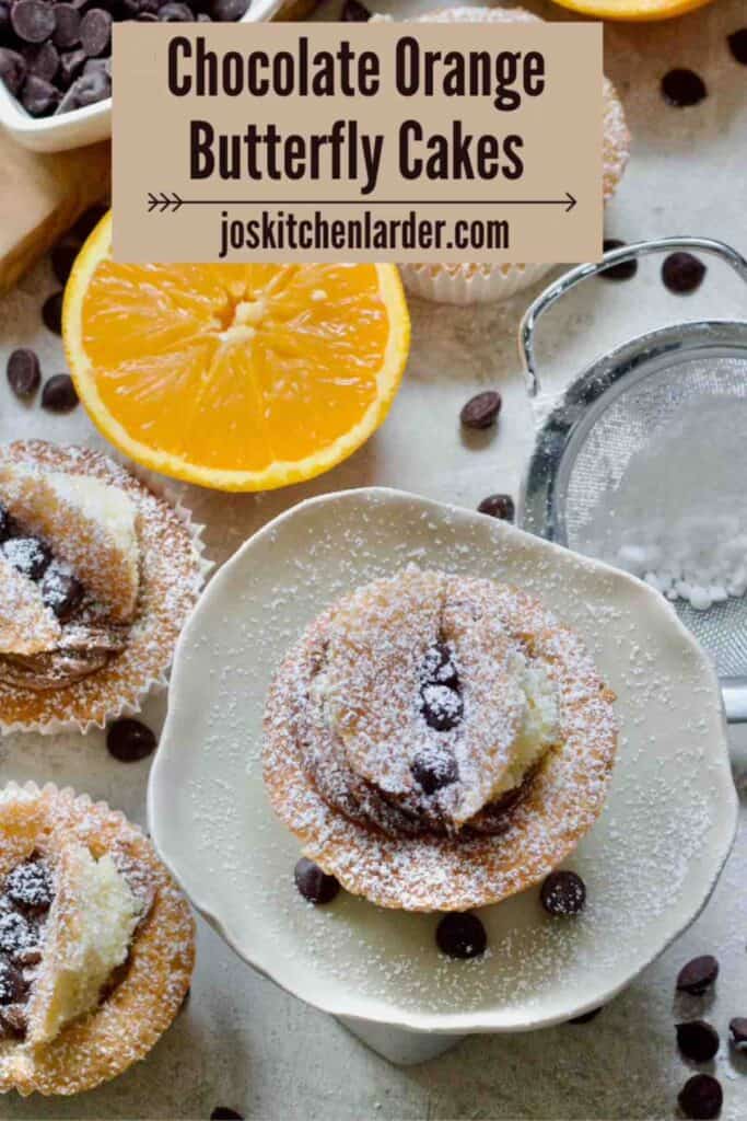 Bird view of a chocolate orange butterfly cake on a small cake stand.