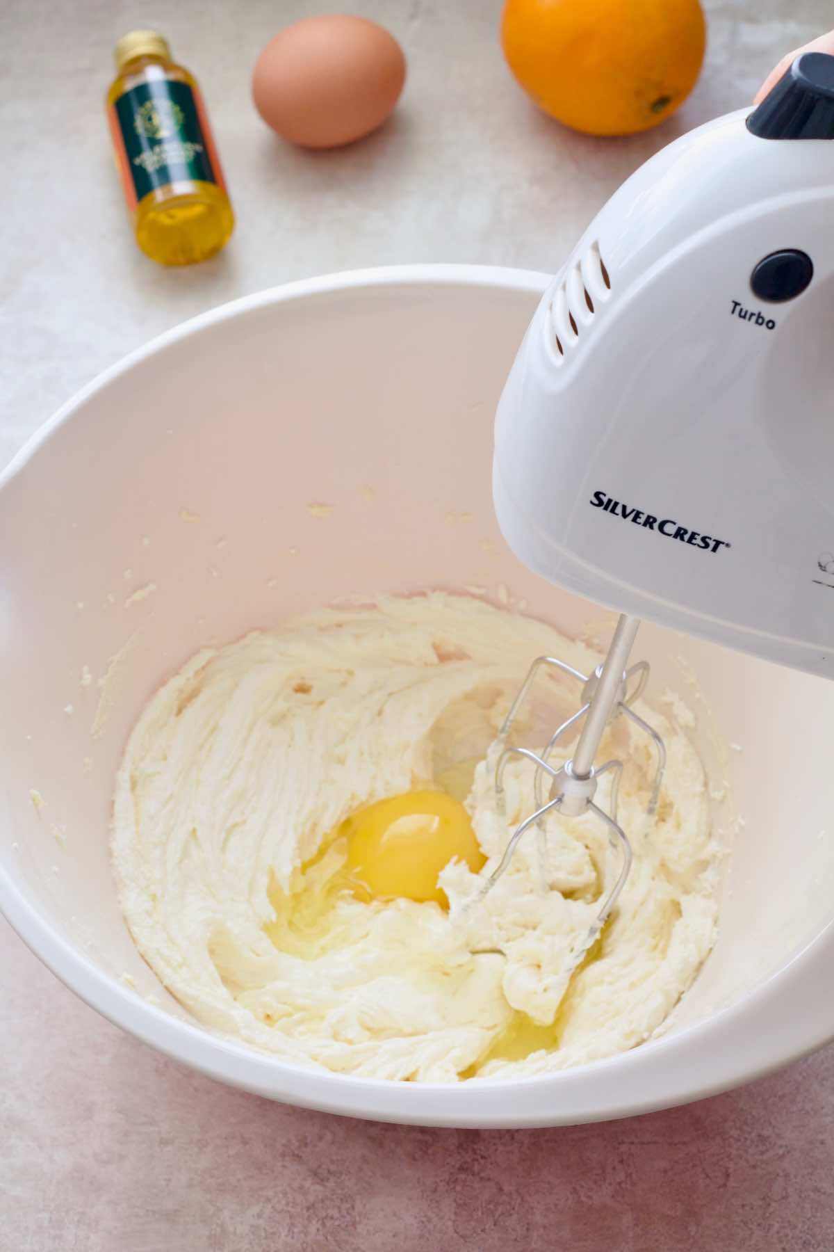 Mixing the eggs into sugar/butter mixture.
