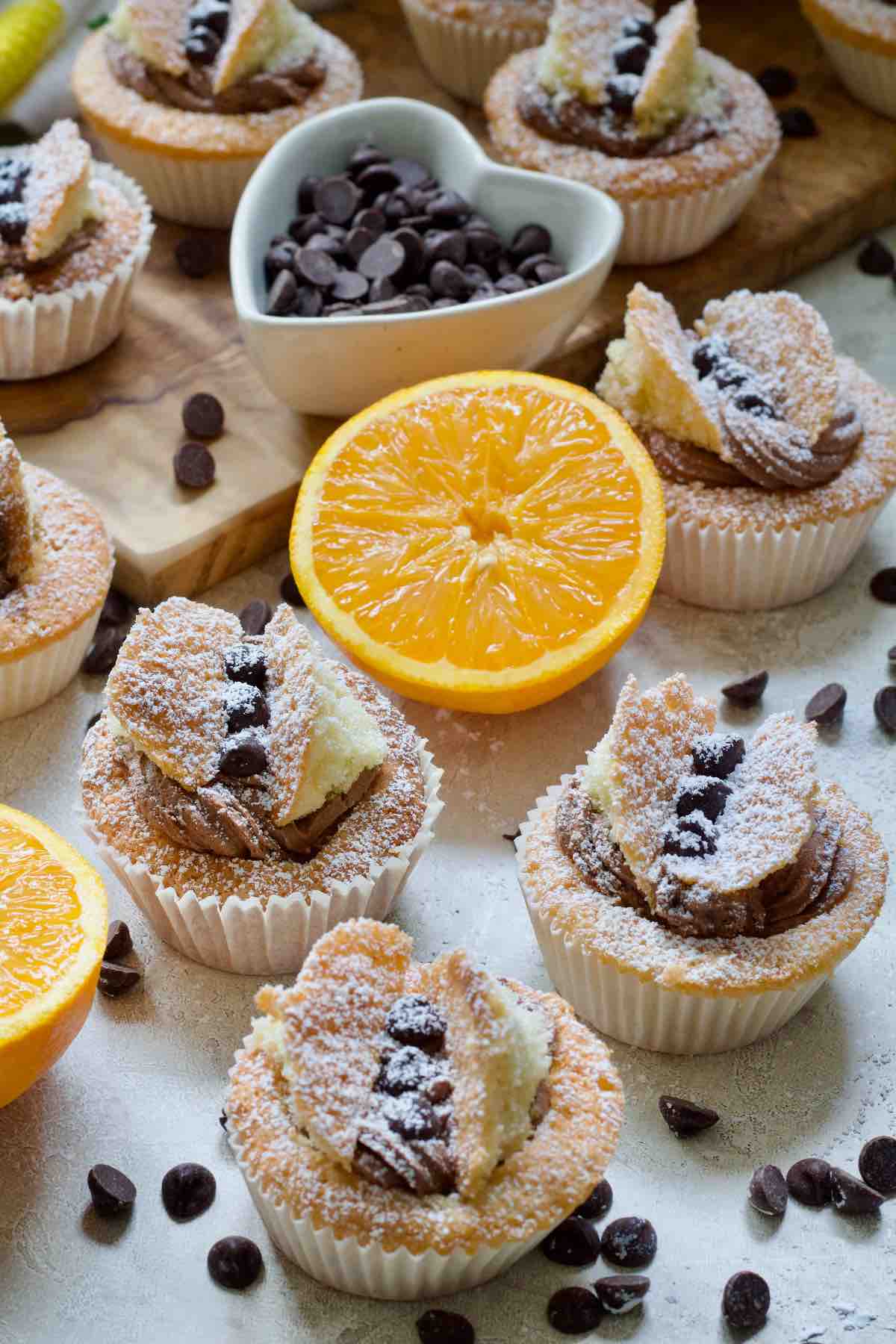 Close up of three chocolate orange butterfly cakes.