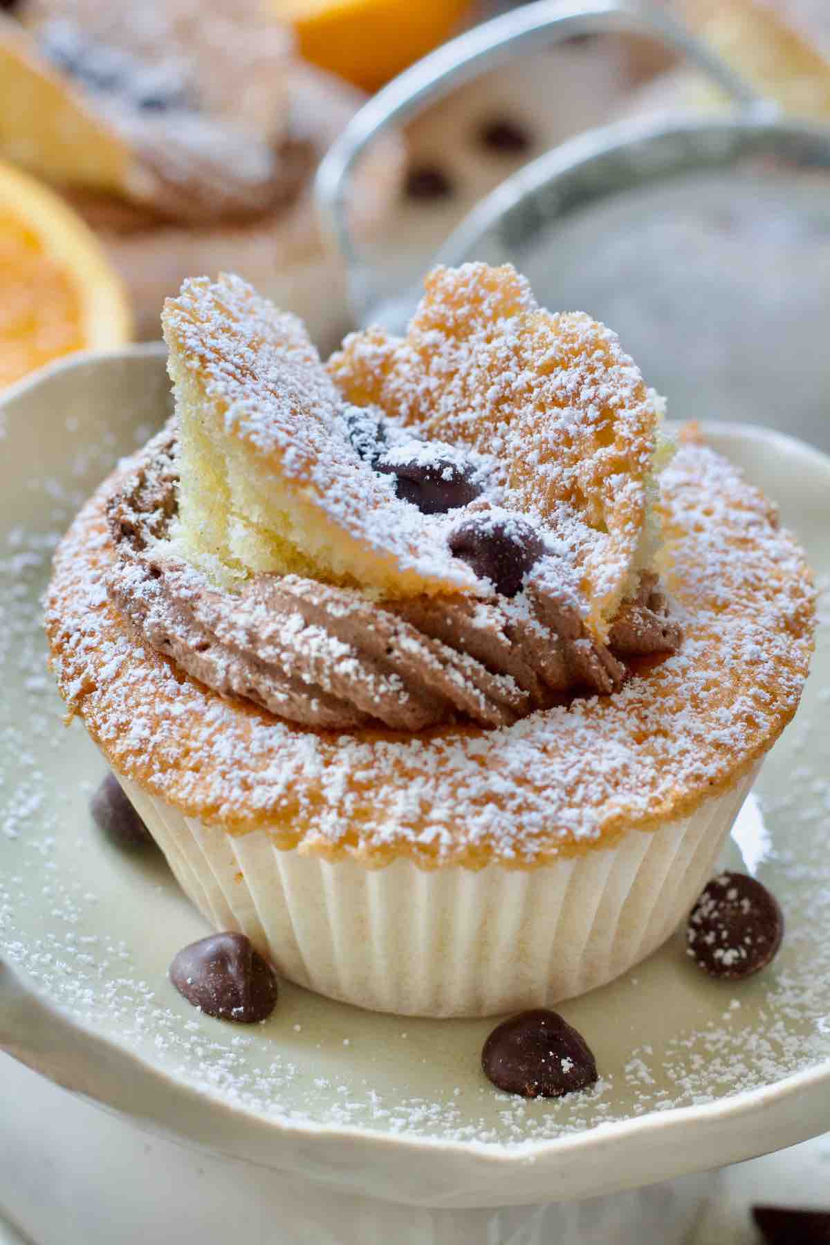 Close up of decorated butterfly cake dusted with icing sugar.