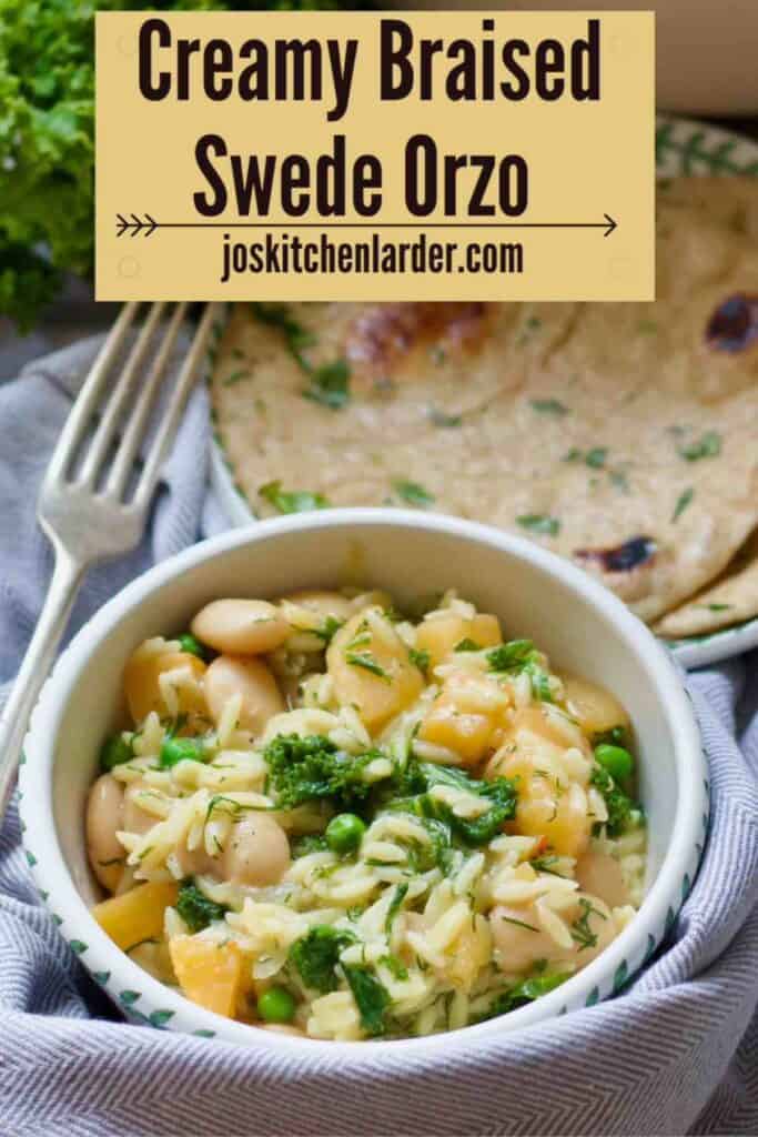 Bowl with portion of creamy braised swede orzo, garlic flatbread behind it.