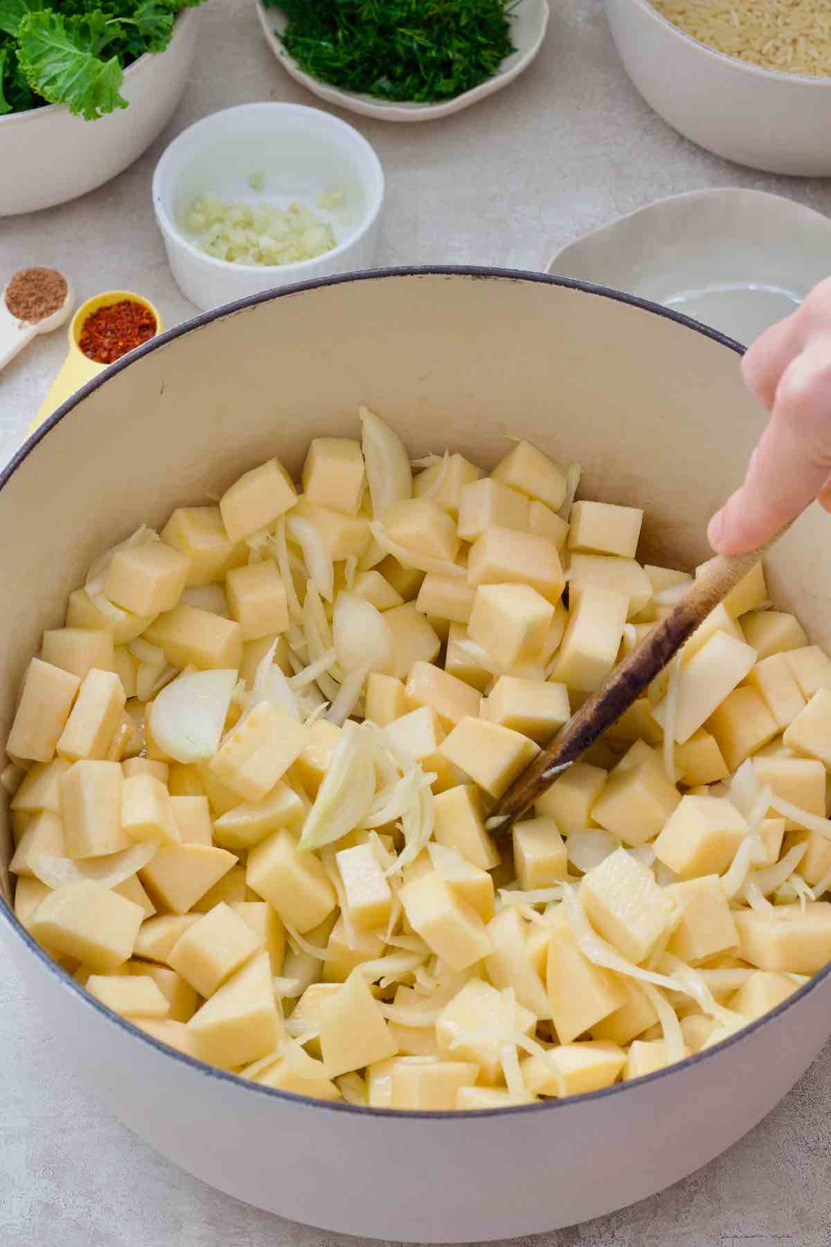 Swede and onions in a pot before braising.
