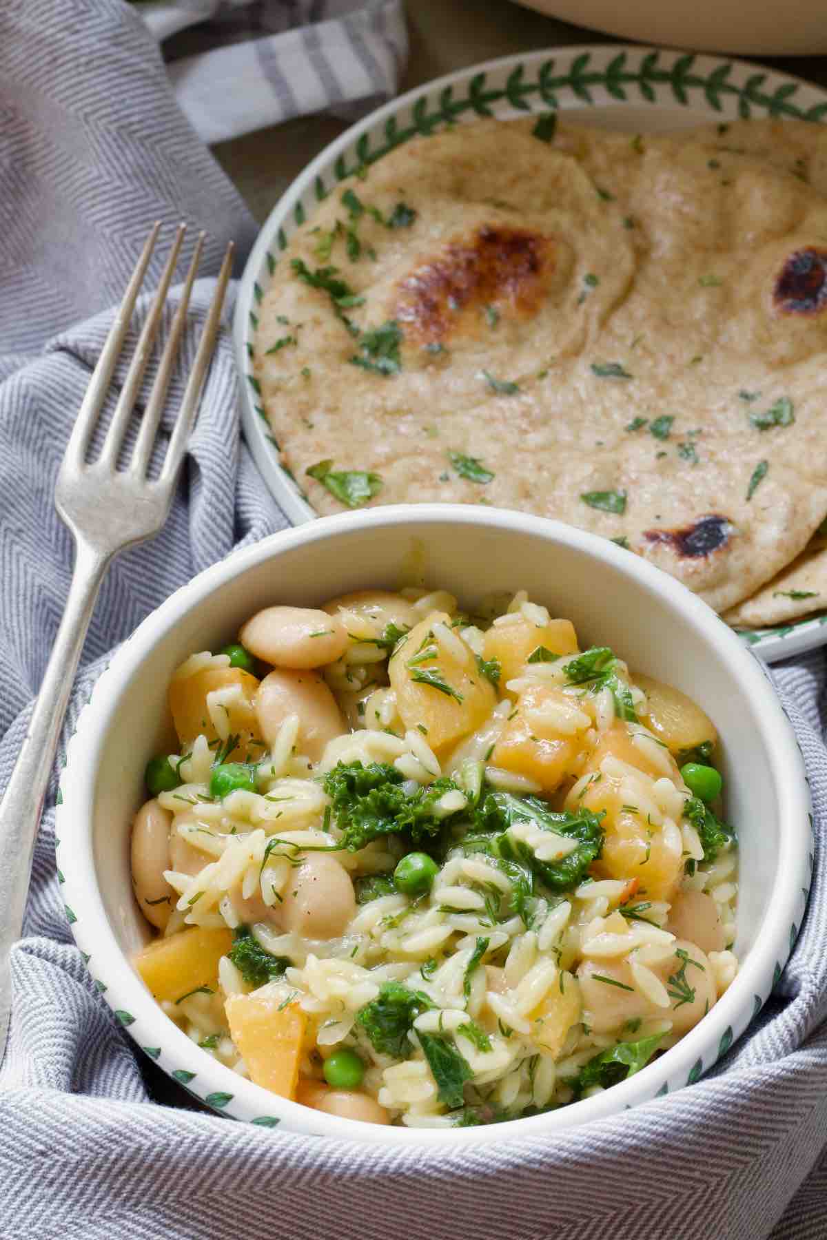 Garlic flatbread served with bowl of orzo pasta.