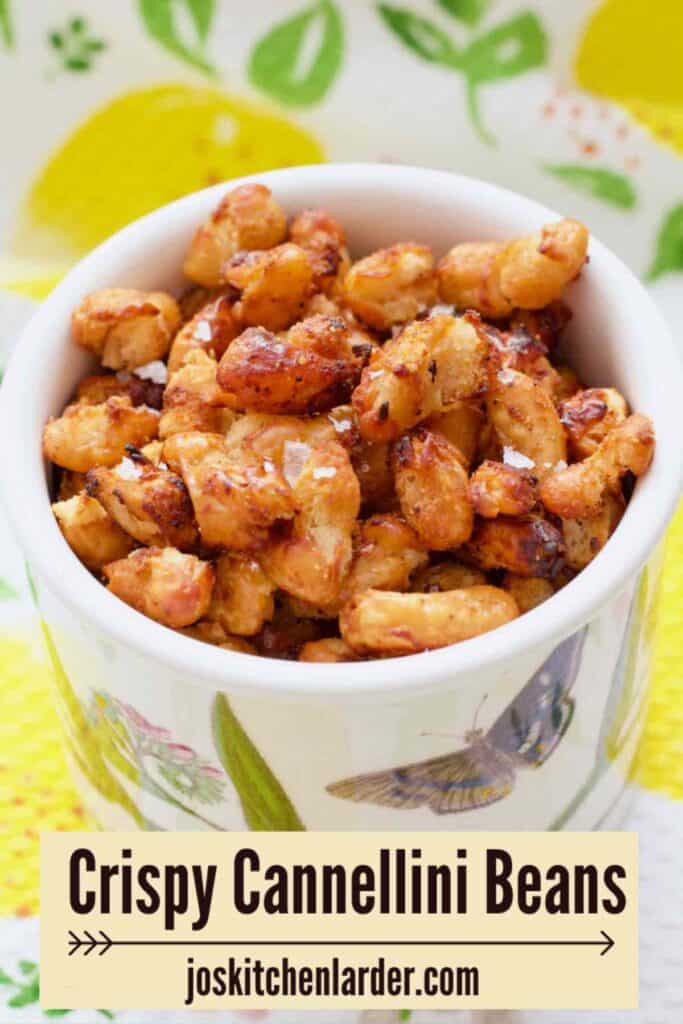 Close up of crispy cannellini beans in a small pot.