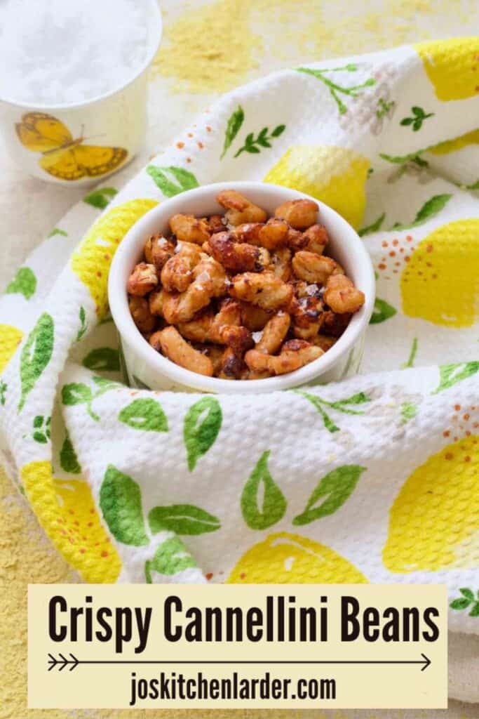 Pot with crispy beans and small pot with sea salt in the background.