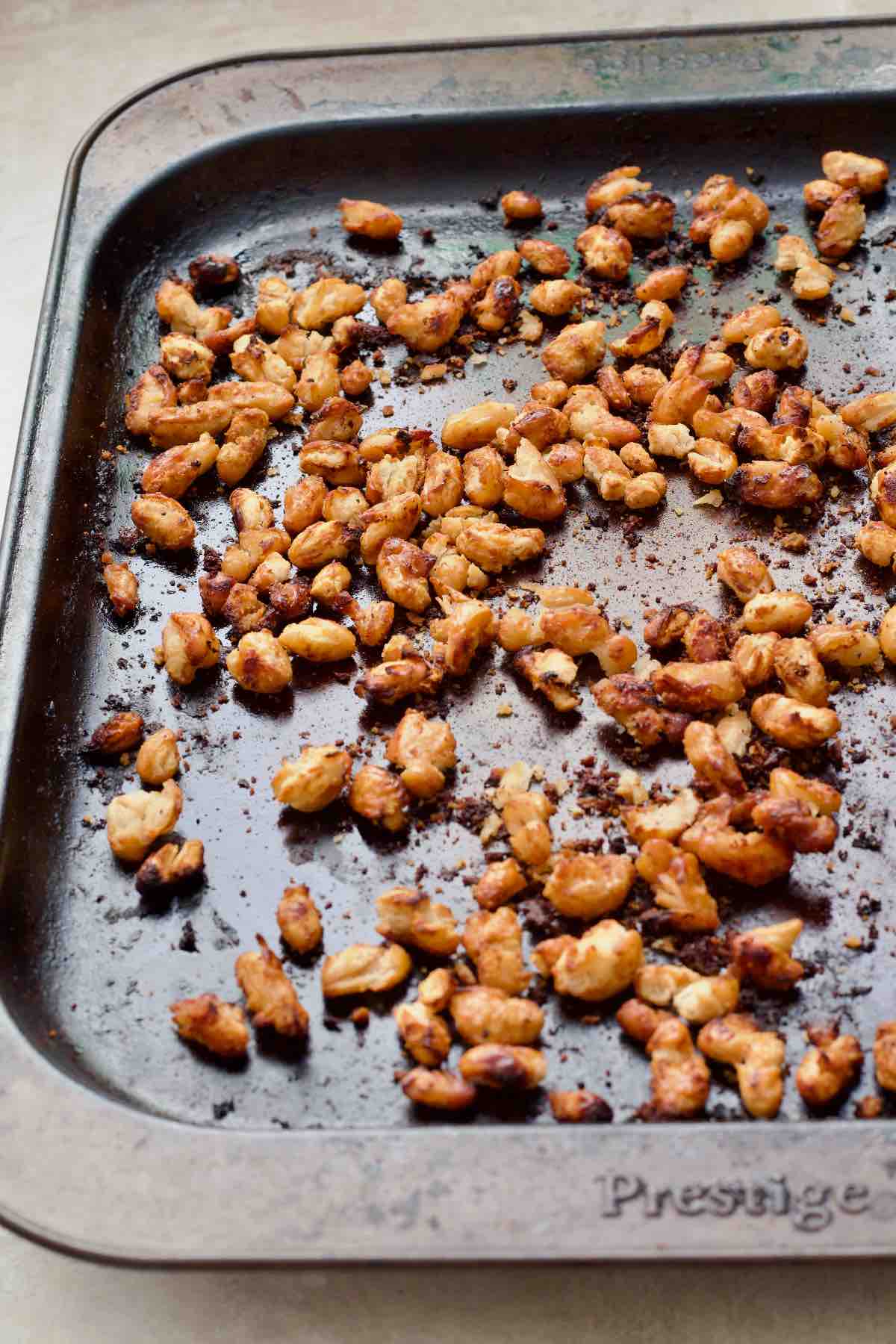 Close up of roasted white beans on a baking tray.