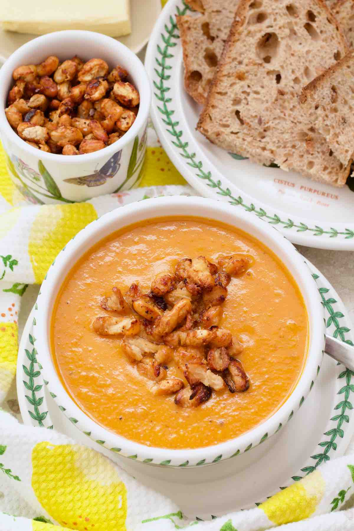Crispy cannellini beans in a small dish and on top of the soup.