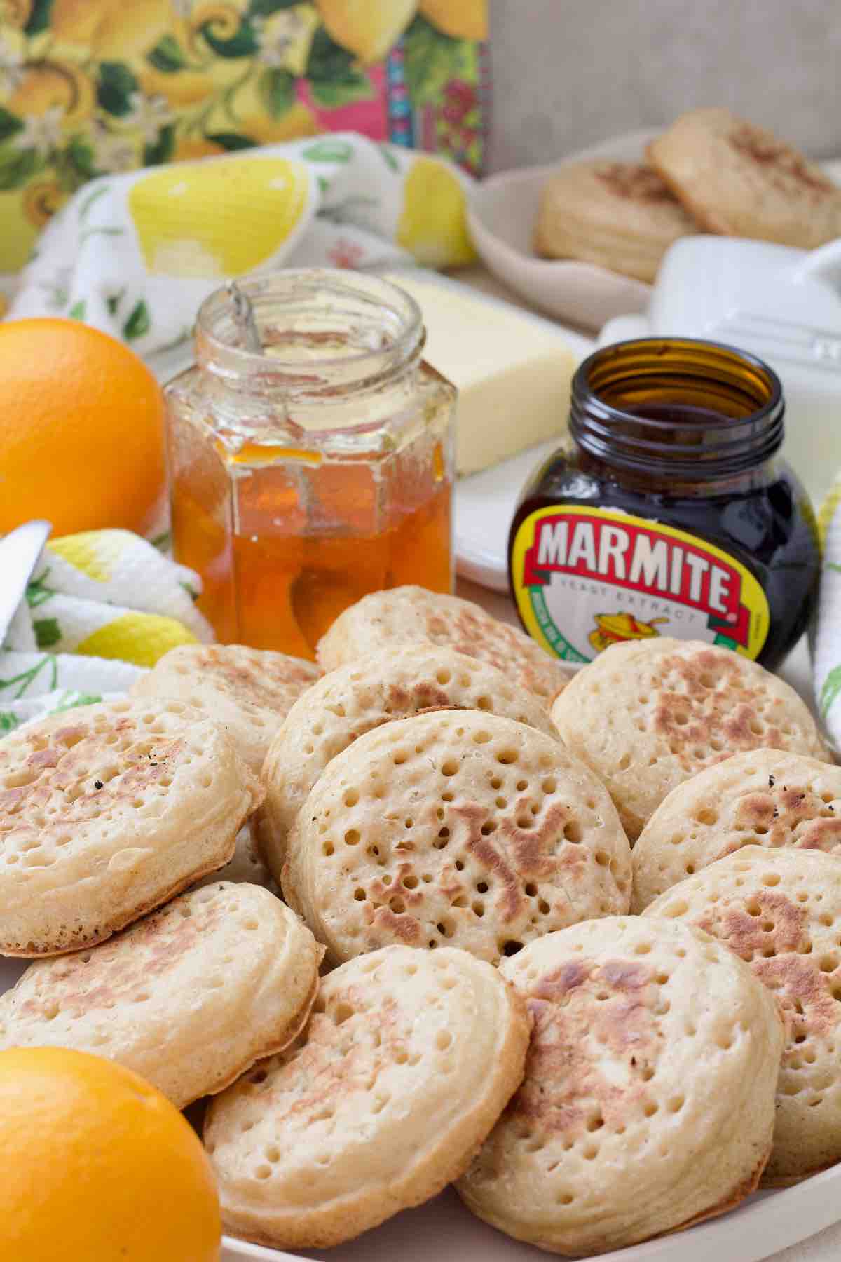 Crumpets forming a ring on a plate with one in the centre.