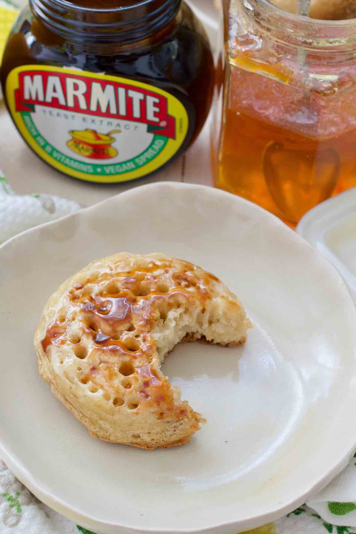 Crumpet with marmite with bite taken out of it.