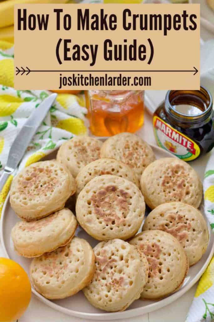 Plate full of crumpets with marmite and marmalade behind.