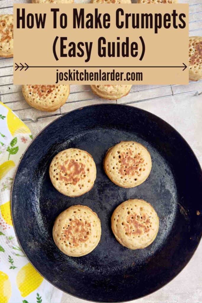 Four cooked crumpets in a pan and more on a cooling rack.