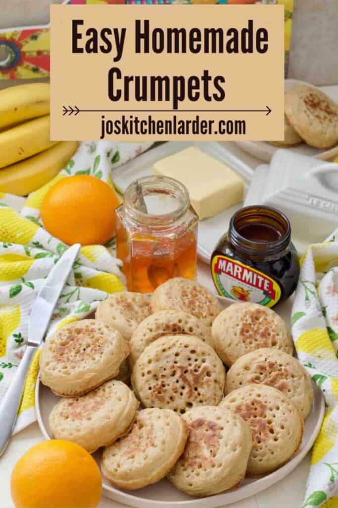Plate full of crumpets, marmalade, marmite and more breakfast things.