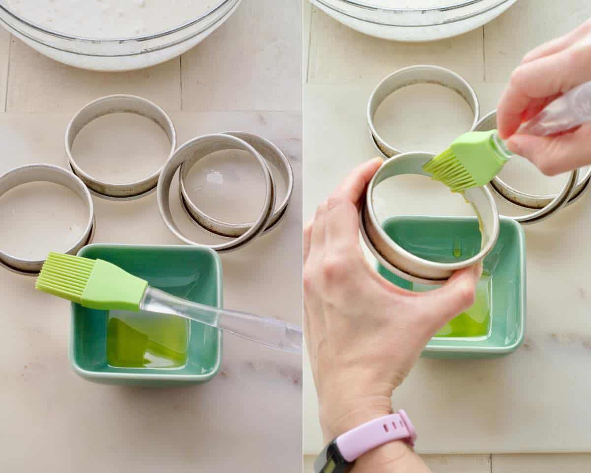 Oiling crumpet rings using silicone pastry brush.