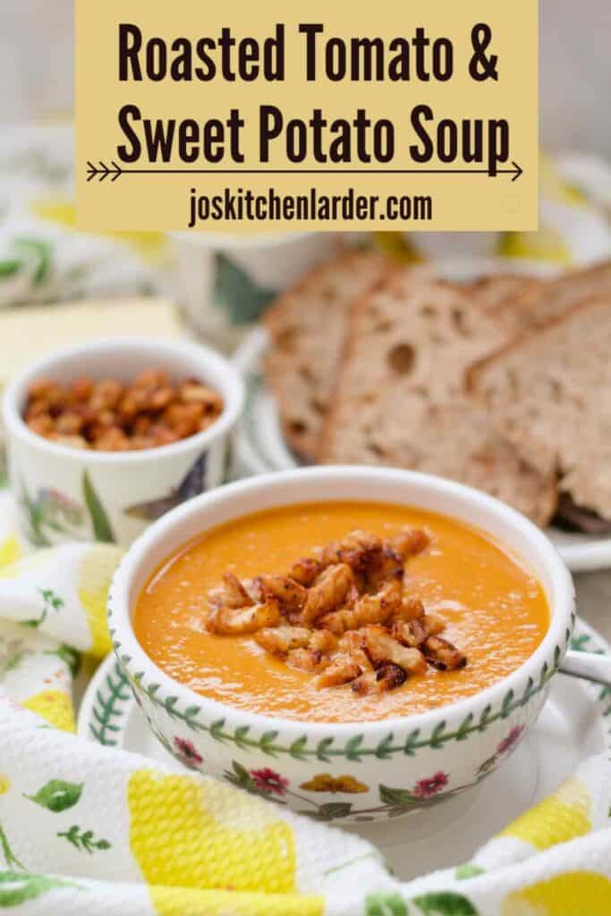 Soup in a bowl with sliced bread and crispy beans in a background.