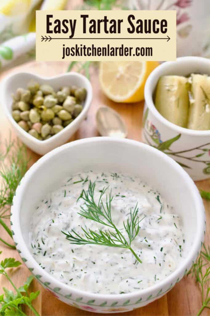 Close up of tartare sauce in a bowl garnished with dill.