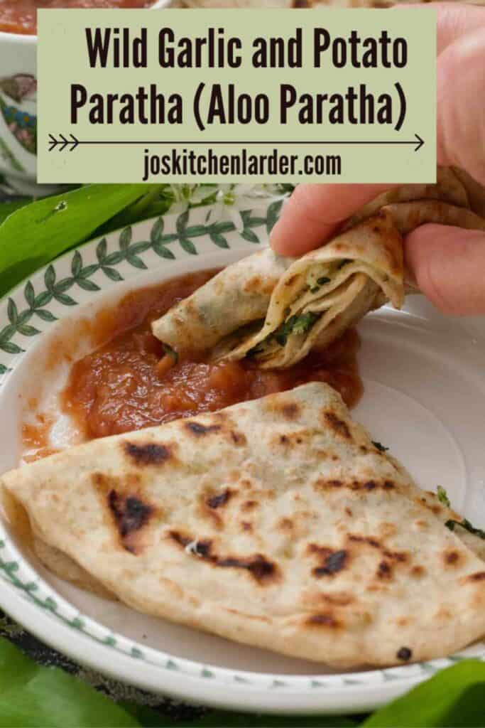 Paratha being dipped in chutney.