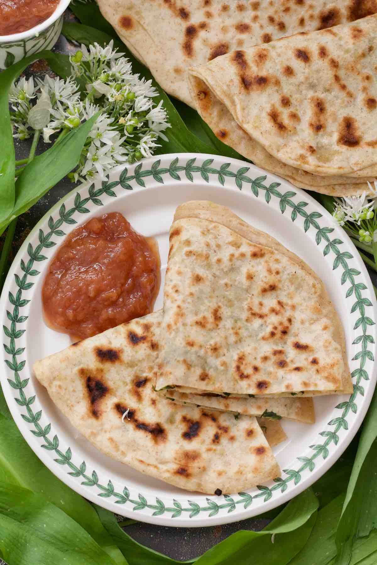 Paratha served on a plate with chutney.