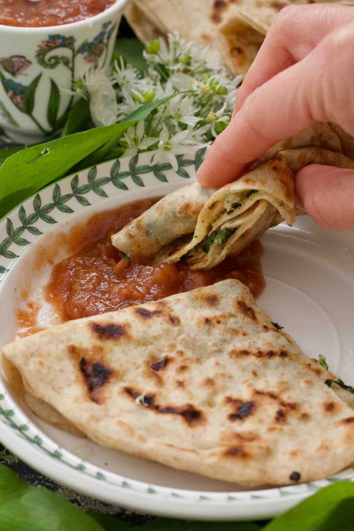 Paratha being dipped in chutney.