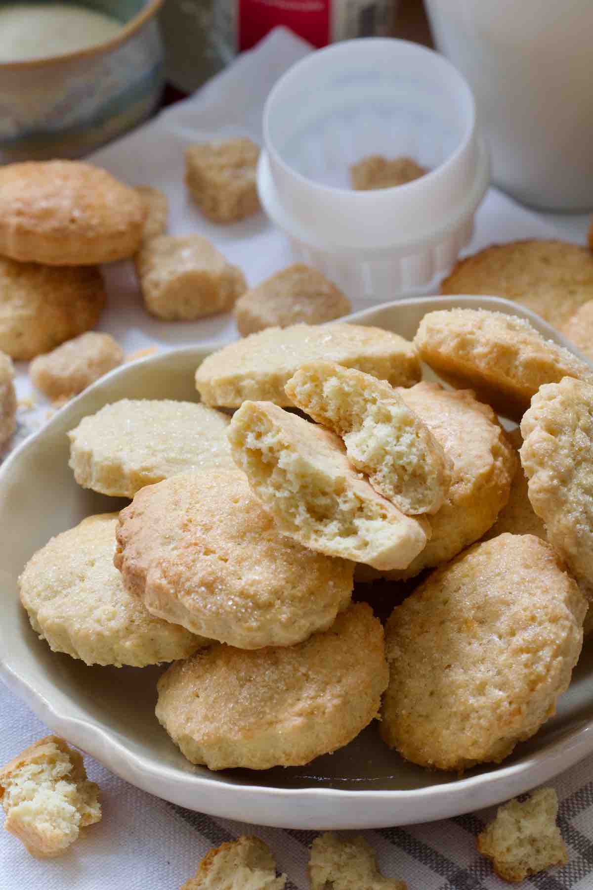Ammonia cookies on a plate with one cookie snapped in half showing its crumb.