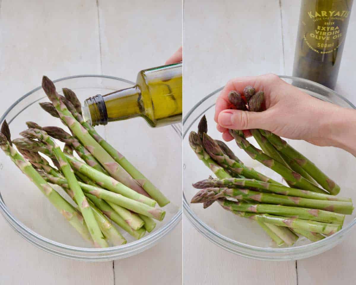 Massaging olive oil into asparagus spears in a bowl.