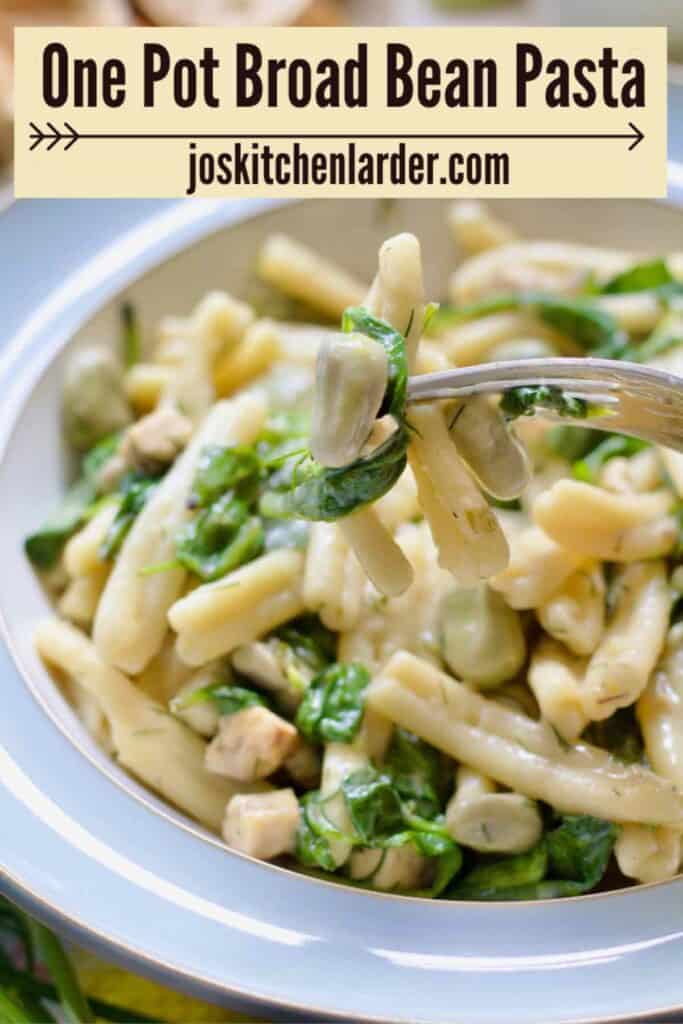 Close up of small bite of broad bean pasta on a fork.