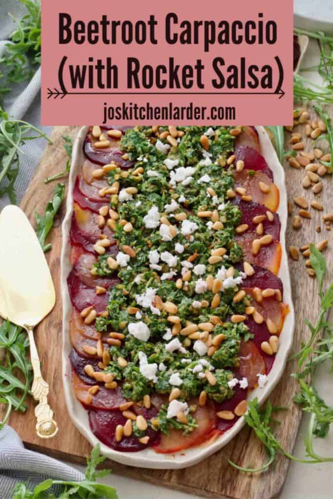 Beetroot carpaccio on a platter with serving spoon on a side.