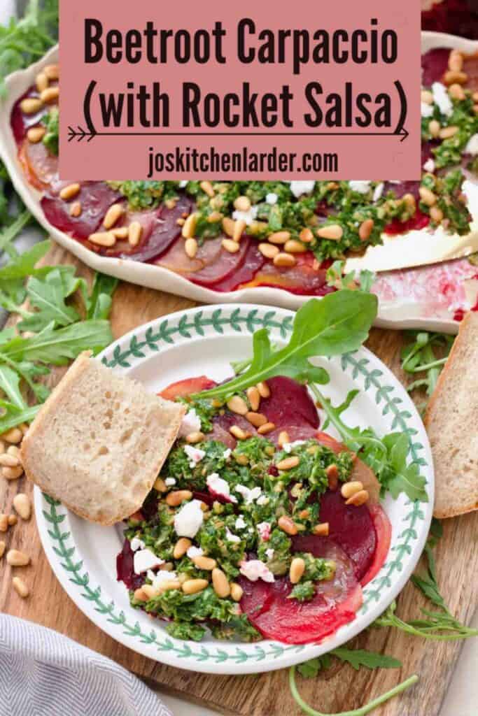 Plated portion of beetroot carpaccio with rocket salsa on a plate with a piece of bread.