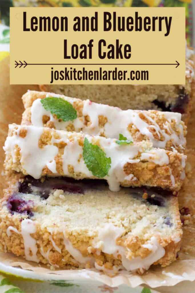 Lemon and blueberry loaf cake partially sliced and garnished with mint.