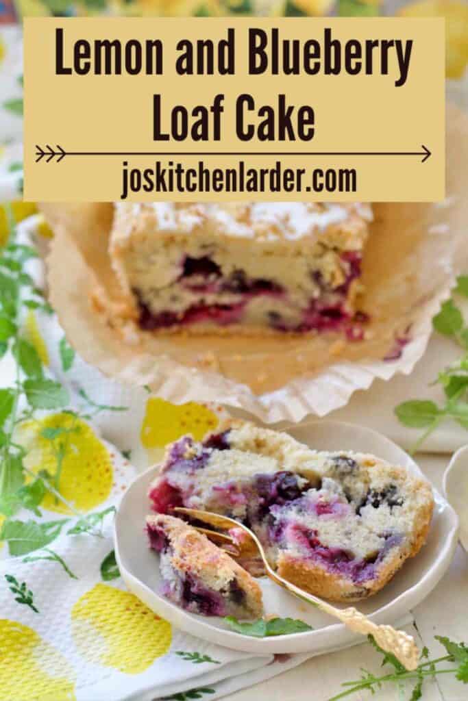 Slice of lemon and blueberry loaf cake on a plate and rest of the loaf behind.