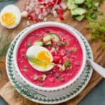 Perfect serving of Polish cold beet soup with all the garnishes and jammy egg.