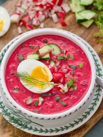 Perfect serving of Polish cold beet soup with all the garnishes and jammy egg.