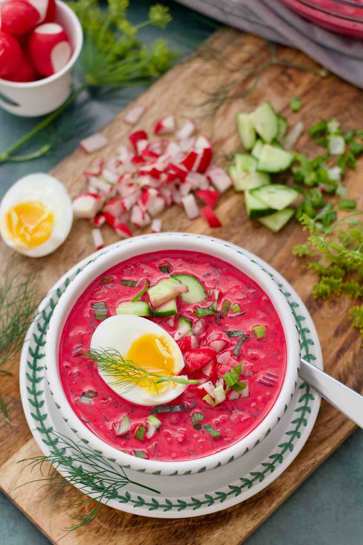 One person serving of Polish cold beet soup topped with jammy egg.