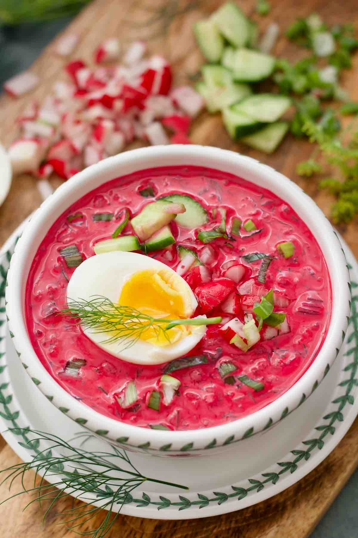 Polish cold beet soup served with a jammy egg, view from the top.