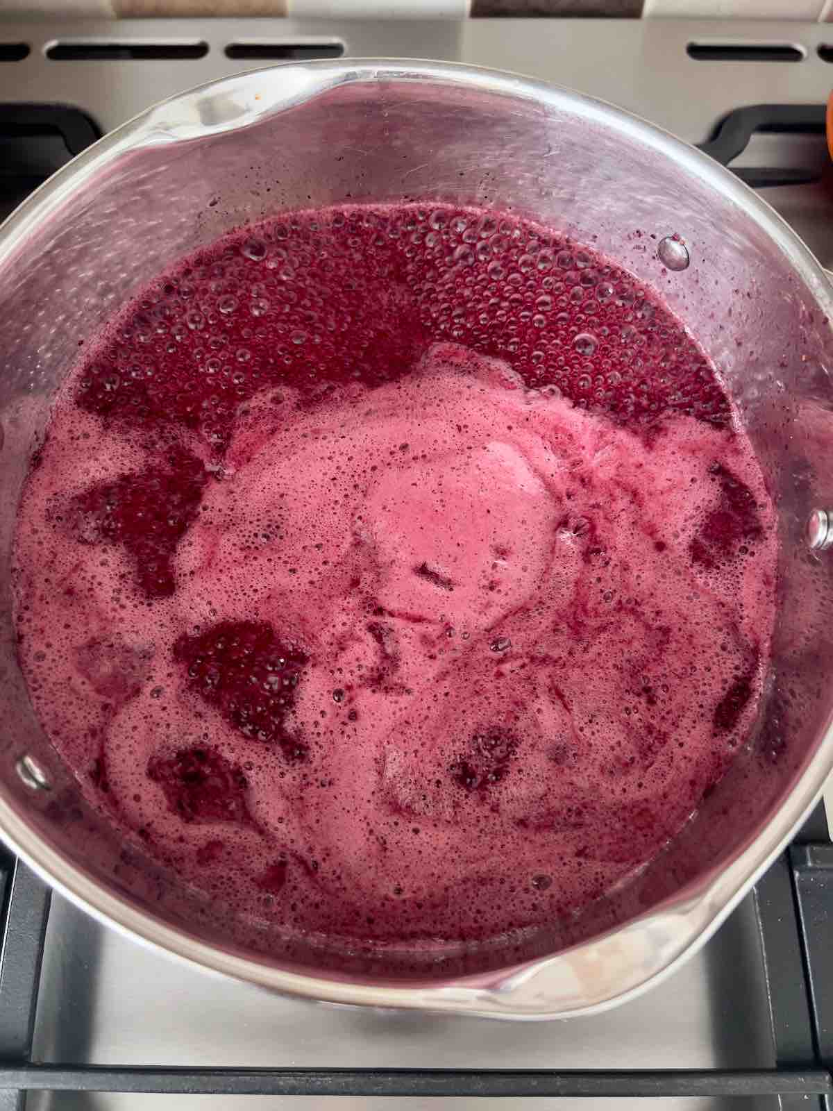 Blueberry cordial boiling rapidly.
