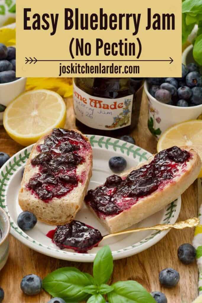 Two pieces of baguette topped with blueberry jam and a jam filled spoon.