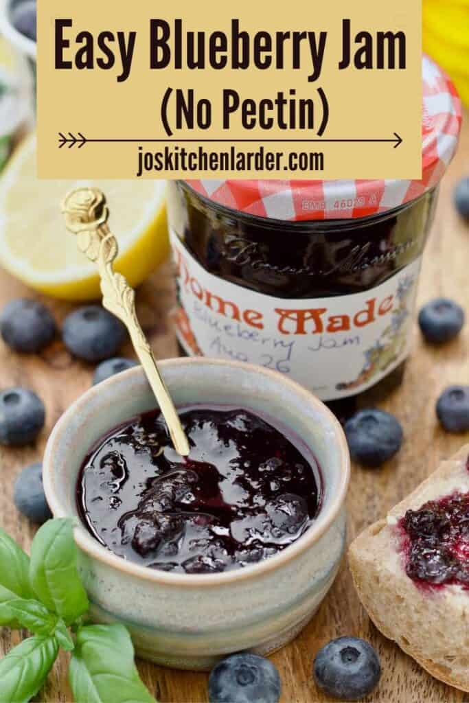 Small bowl with blueberry jam and a spoon and labelled jam jar behind it.
