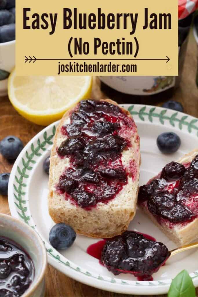 Close up of a piece of baguette topped with blueberry jam and some jam on a spoon.