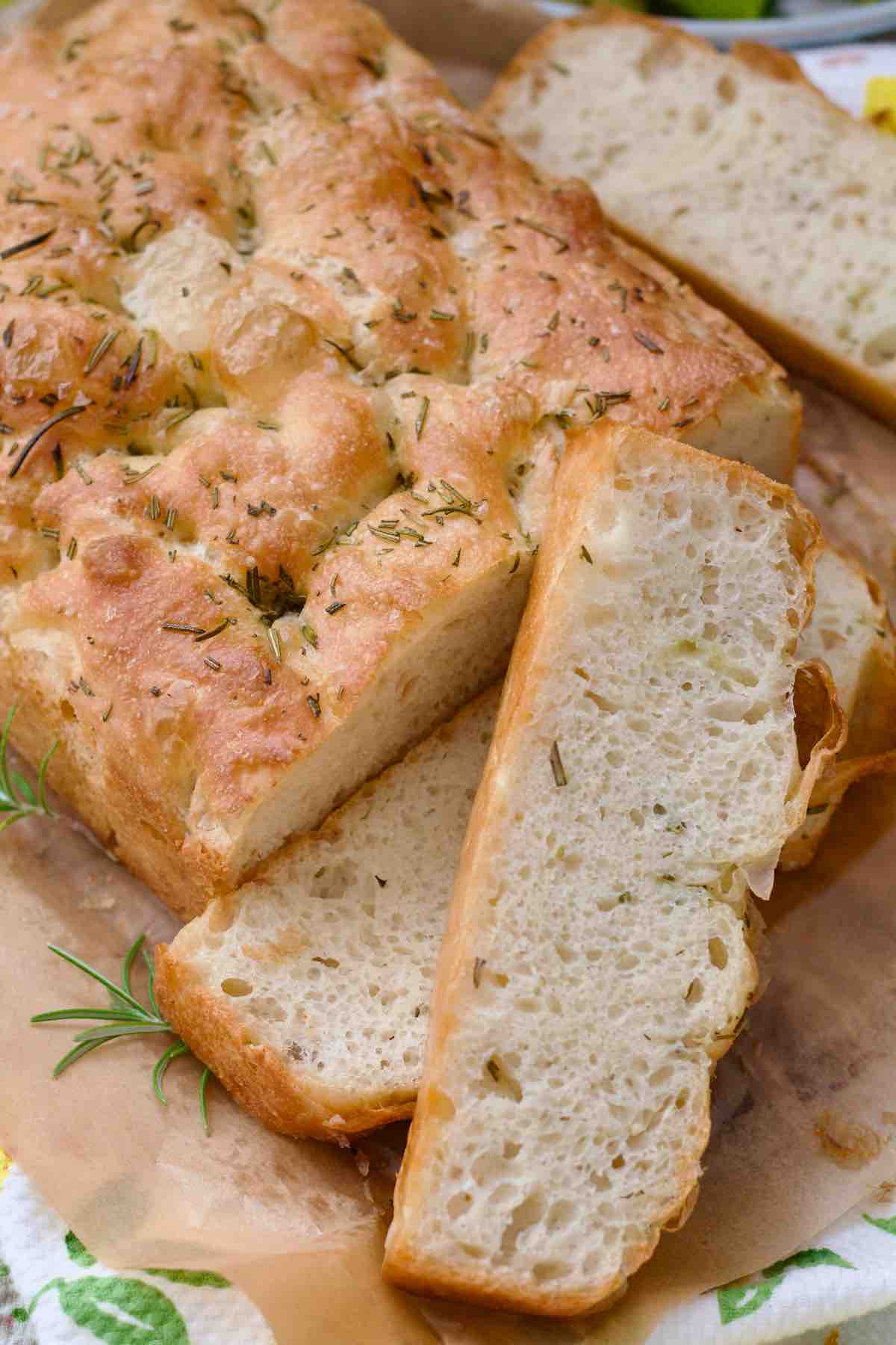 Bird view of focaccia with few slices already cut.